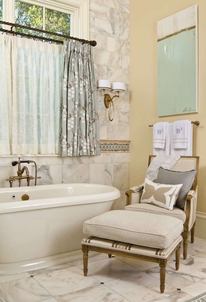 This is an example of a traditional bathroom in Dallas with a freestanding tub and white tile.