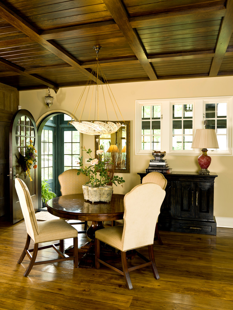 Inspiration for a traditional dining room in Chicago with beige walls and dark hardwood floors.