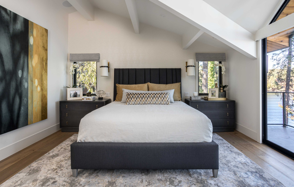 This is an example of a medium sized contemporary master bedroom in Sacramento with white walls, medium hardwood flooring, a standard fireplace, a tiled fireplace surround, brown floors, exposed beams and wallpapered walls.