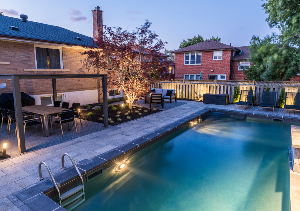 Pool fountain - mid-sized transitional backyard concrete paver and l-shaped lap pool fountain idea in Toronto
