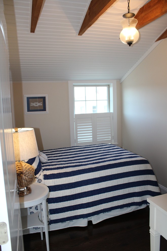 Design ideas for a small beach style guest bedroom in Boston with beige walls and dark hardwood floors.