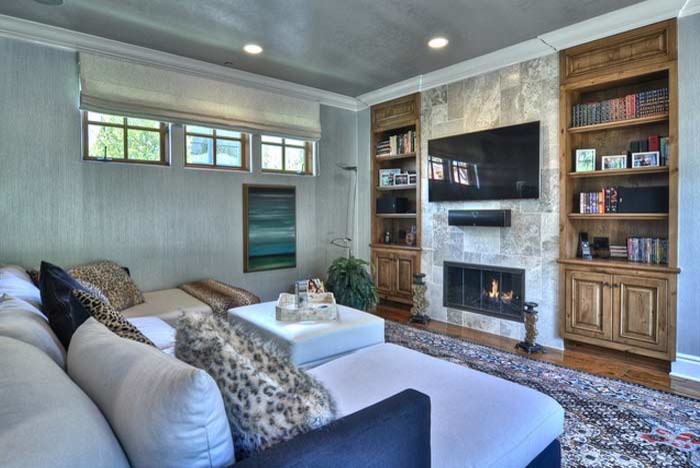 Inspiration for a large contemporary enclosed family room in Orange County with grey walls and a wall-mounted tv.