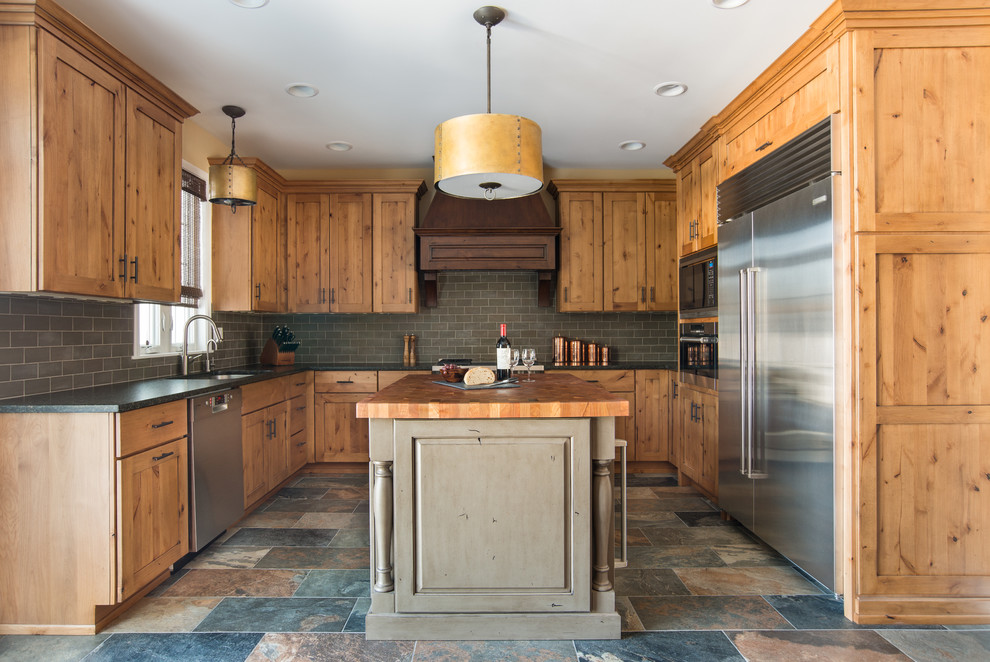 Inspiration for a mid-sized country u-shaped eat-in kitchen in Chicago with an undermount sink, shaker cabinets, light wood cabinets, granite benchtops, grey splashback, stainless steel appliances, porcelain floors, multi-coloured floor and slate splashback.