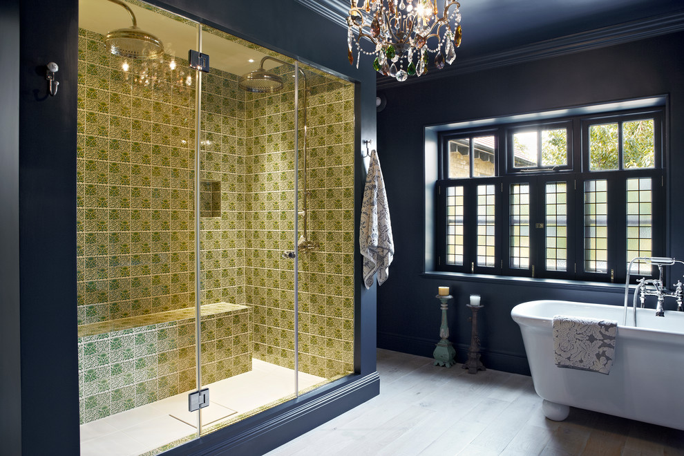 Inspiration for a contemporary bathroom in London with a freestanding tub, a double shower, multi-coloured tile, blue walls and light hardwood floors.