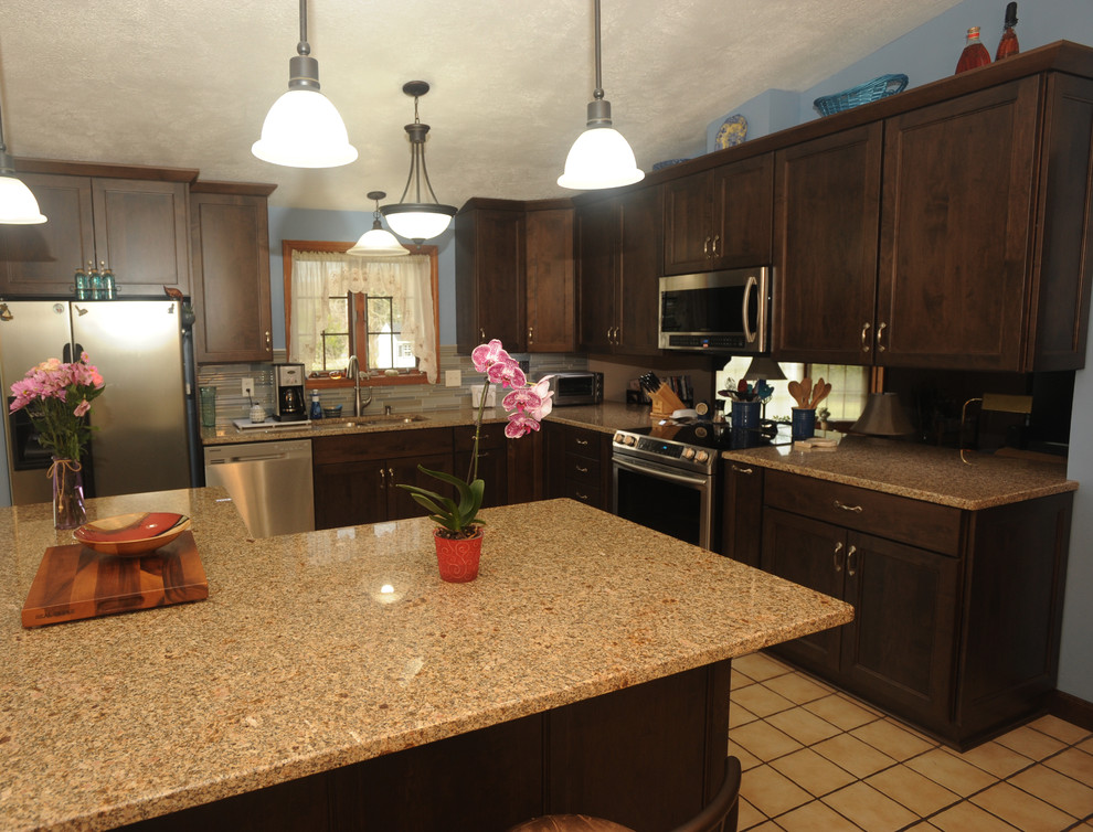 Eat-in kitchen - mid-sized transitional l-shaped ceramic tile eat-in kitchen idea with an undermount sink, recessed-panel cabinets, dark wood cabinets, granite countertops, multicolored backsplash, glass tile backsplash, stainless steel appliances and an island