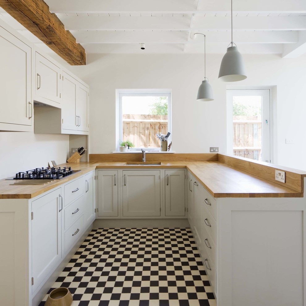 Design ideas for a small country u-shaped kitchen in London with an undermount sink, recessed-panel cabinets, wood benchtops and multi-coloured floor.