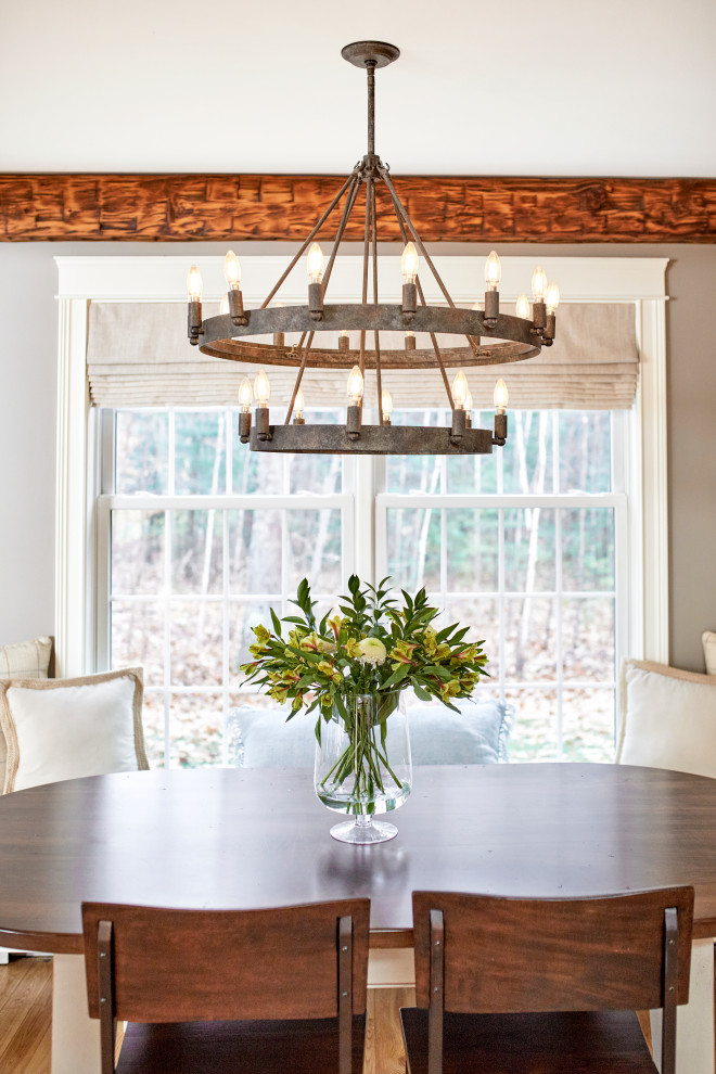 Design ideas for a country dining room in Portland Maine with beige walls, light hardwood floors and exposed beam.