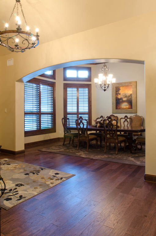 This is an example of a large traditional separate dining room in Austin with beige walls and dark hardwood floors.