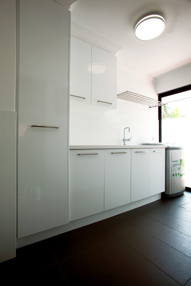 Design ideas for a mid-sized transitional u-shaped dedicated laundry room in Perth with an undermount sink, flat-panel cabinets, white walls, porcelain floors and white cabinets.