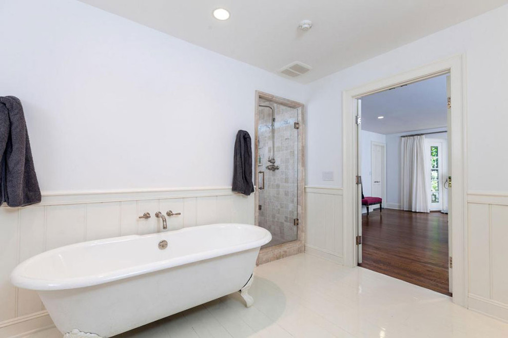 Large transitional master marble floor and white floor claw-foot bathtub photo with recessed-panel cabinets, white cabinets, white walls, an undermount sink and a hinged shower door