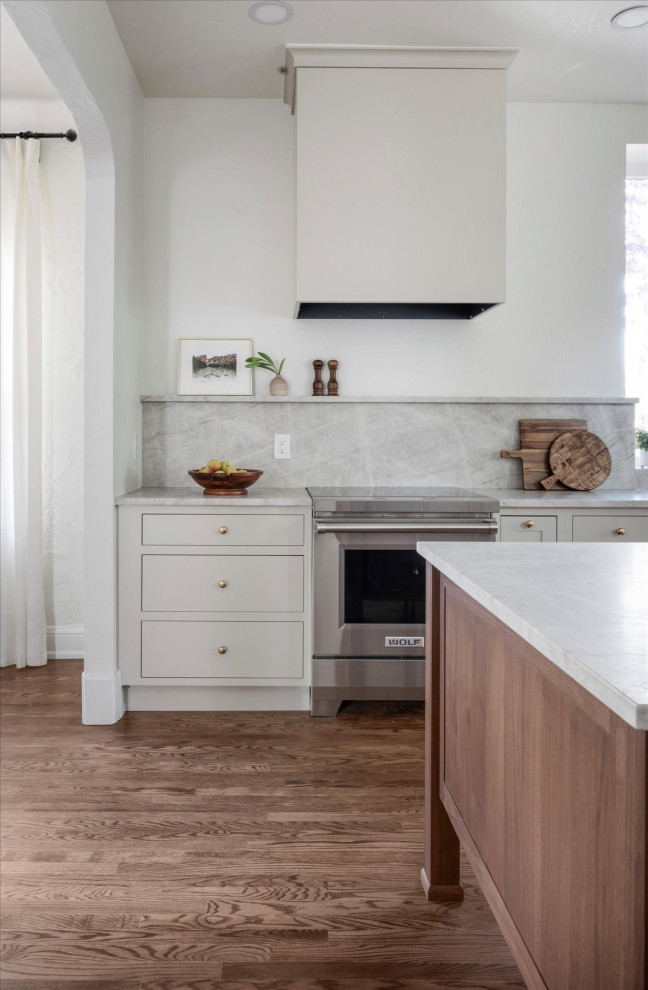 Inspiration for a mid-sized transitional medium tone wood floor and brown floor eat-in kitchen remodel in Denver with white walls and a standard fireplace