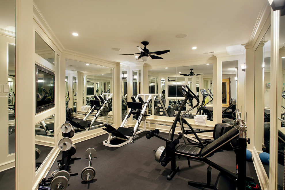This is an example of a mediterranean home weight room in Chicago with beige walls and grey floor.