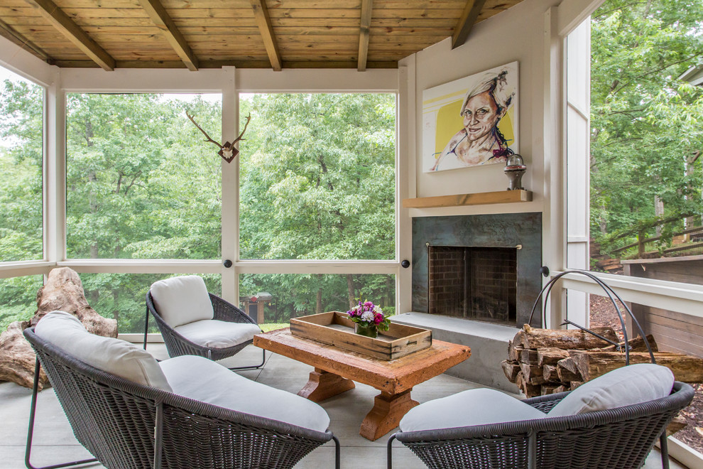 This is an example of a country sunroom in Atlanta with concrete floors, a corner fireplace and a standard ceiling.