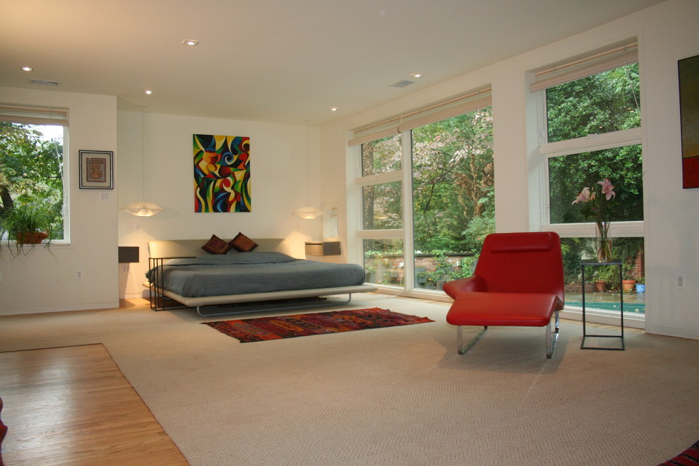 Photo of a contemporary master bedroom in DC Metro with white walls and light hardwood floors.