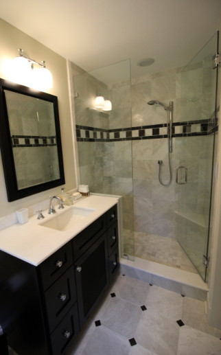 This is an example of a mid-sized transitional master bathroom in St Louis with an undermount sink, dark wood cabinets, marble benchtops, an alcove shower and marble floors.