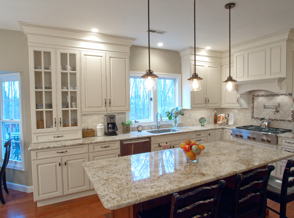 Photo of a large transitional l-shaped eat-in kitchen in Philadelphia with an undermount sink, beaded inset cabinets, white cabinets, granite benchtops, white splashback, subway tile splashback, stainless steel appliances, medium hardwood floors and with island.