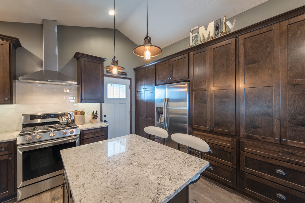 Enclosed kitchen - large rustic u-shaped dark wood floor and brown floor enclosed kitchen idea in Minneapolis with a double-bowl sink, shaker cabinets, dark wood cabinets, granite countertops, white backsplash, subway tile backsplash, stainless steel appliances and an island