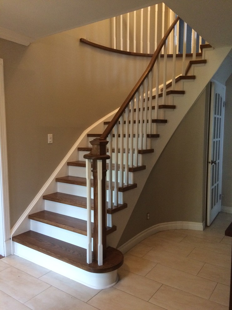 Inspiration for a mid-sized contemporary wood curved staircase in Toronto with wood risers and wood railing.