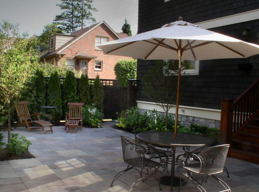 Inspiration for a small contemporary backyard patio in Seattle with natural stone pavers.