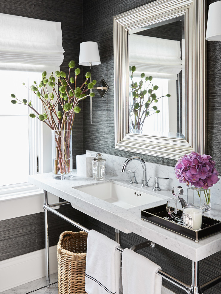 Transitional powder room in San Francisco with marble benchtops, grey walls, an undermount sink and white benchtops.