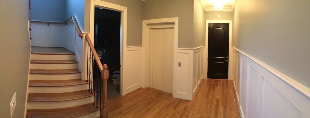 Design ideas for a small modern hallway in Louisville with beige walls and medium hardwood floors.