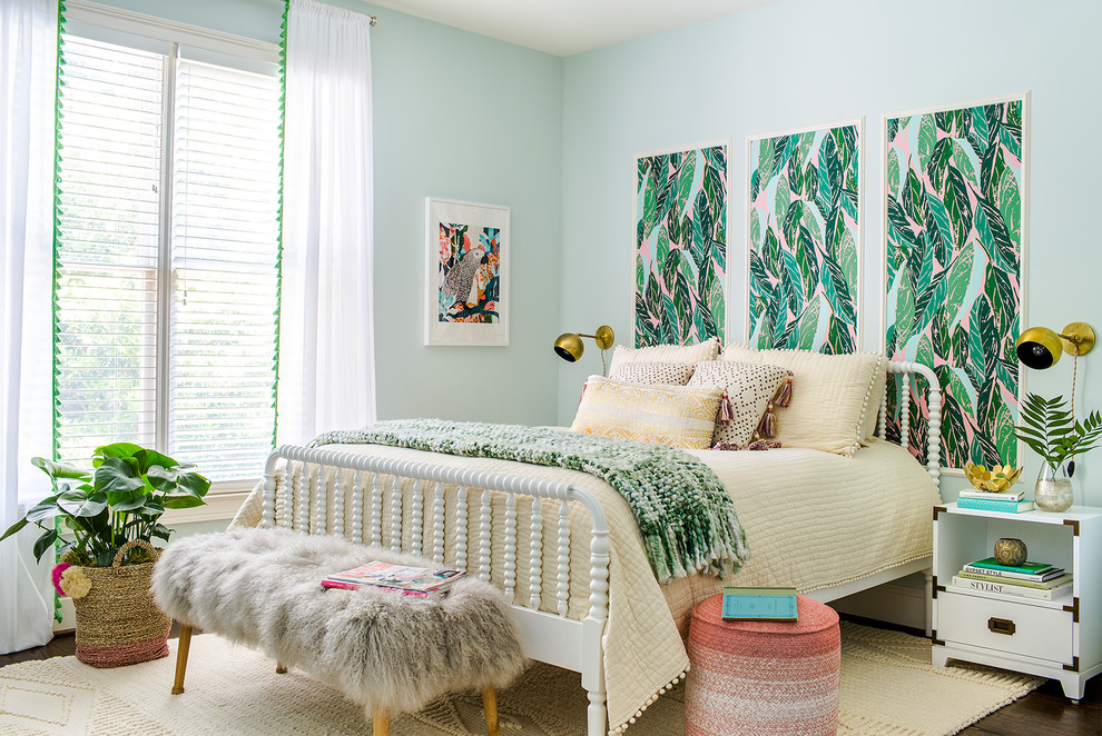 Photo of a tropical bedroom in Atlanta with dark hardwood floors and green walls.