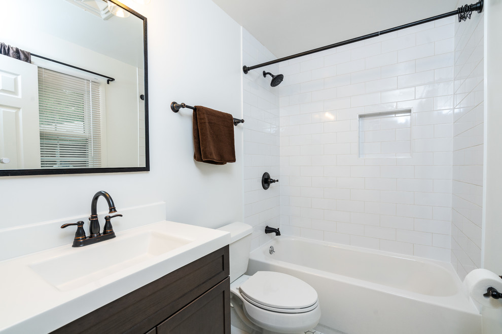 Photo of a small contemporary bathroom in DC Metro with brown cabinets and white tile.