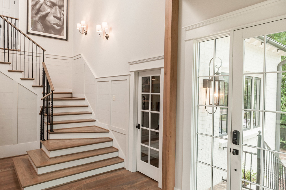 Photo of a transitional wood l-shaped staircase in Birmingham with painted wood risers.