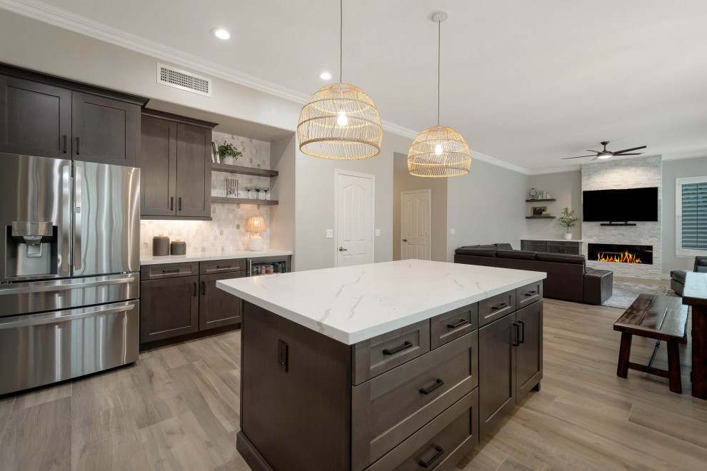 Example of a large porcelain tile and brown floor eat-in kitchen design in Phoenix with an undermount sink, shaker cabinets, quartz countertops, multicolored backsplash, marble backsplash, stainless steel appliances, an island and white countertops