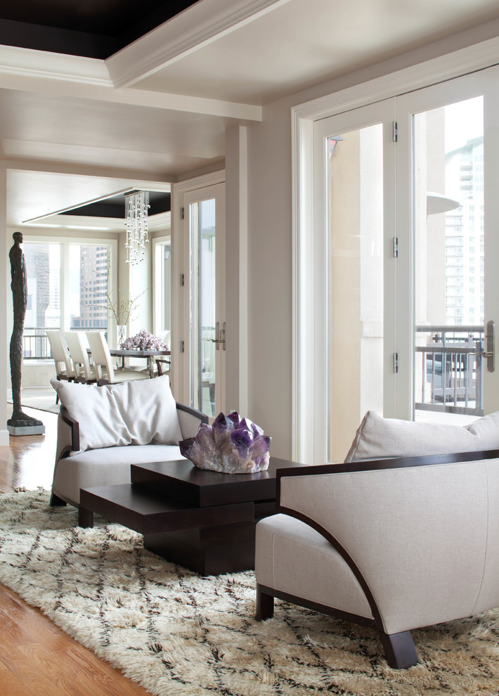 Example of a trendy formal medium tone wood floor living room design in Denver with white walls