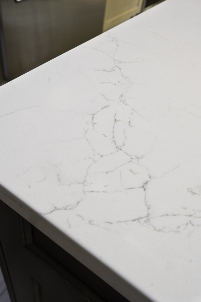 Inspiration for a large transitional eat-in kitchen remodel in Chicago with recessed-panel cabinets, light wood cabinets, quartz countertops, gray backsplash, porcelain backsplash, an island and white countertops