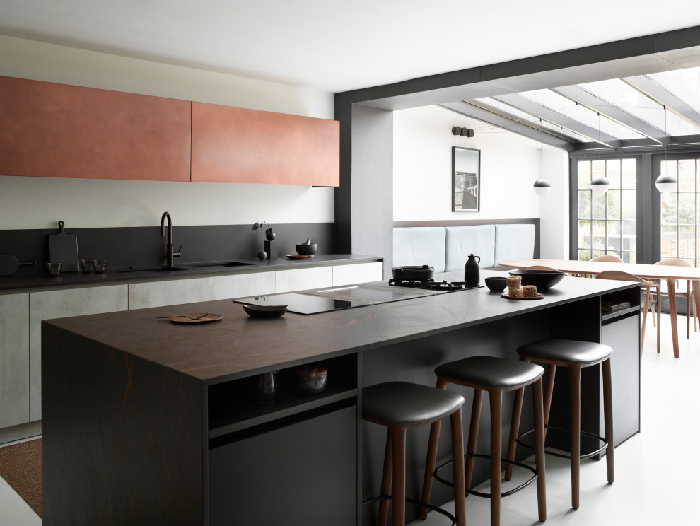 Inspiration for a contemporary eat-in kitchen in London with a double-bowl sink, flat-panel cabinets, grey cabinets, concrete floors, with island, grey floor and grey benchtop.