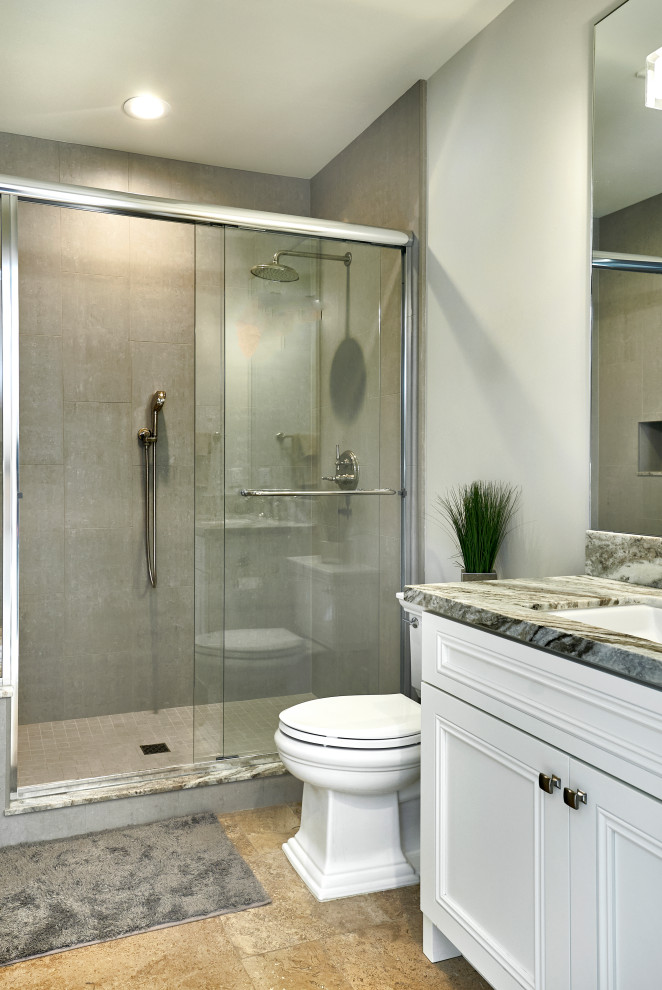 Inspiration for a small transitional bathroom in San Francisco with white cabinets, an alcove shower, a two-piece toilet, gray tile, ceramic tile, grey walls, limestone floors, an undermount sink, brown floor, a sliding shower screen, a single vanity, a built-in vanity, beaded inset cabinets and multi-coloured benchtops.