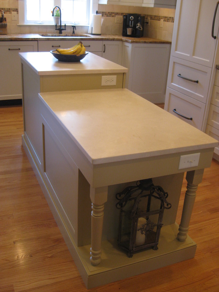 Example of a mid-sized transitional l-shaped light wood floor open concept kitchen design in Bridgeport with shaker cabinets, white cabinets, white backsplash, porcelain backsplash, an undermount sink, granite countertops, stainless steel appliances and an island