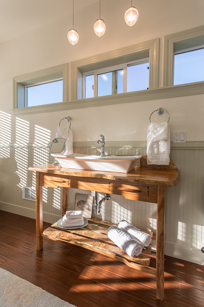 Country bathroom in Seattle with a vessel sink, medium wood cabinets, white walls, dark hardwood floors and open cabinets.