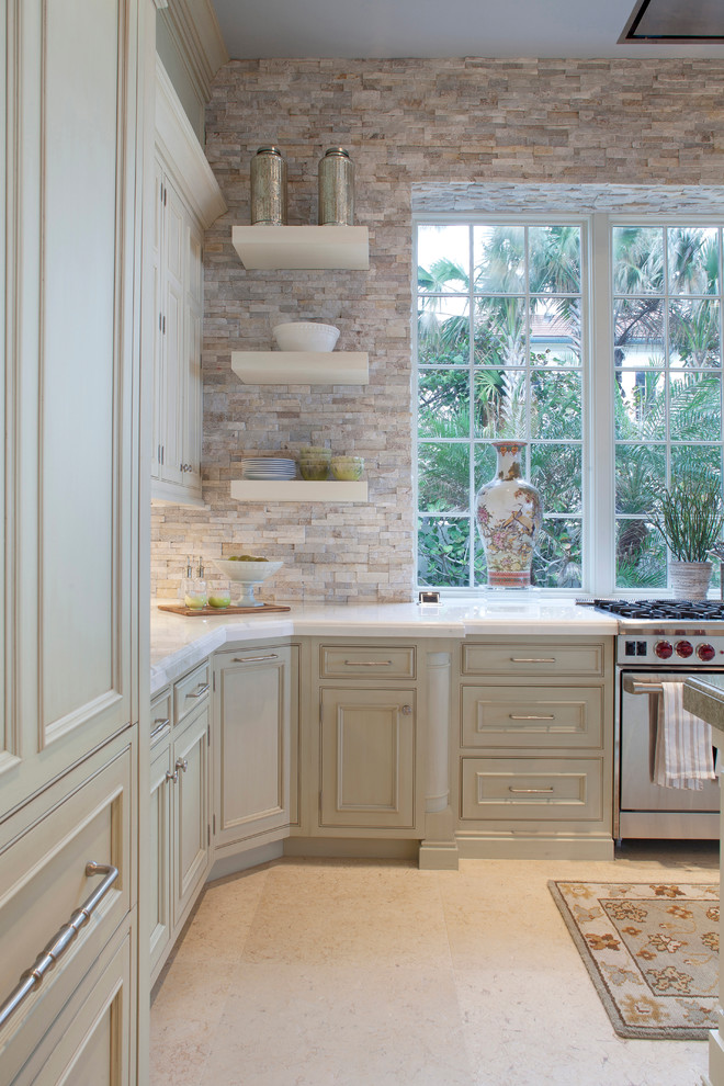Example of a transitional eat-in kitchen design in Miami with limestone countertops