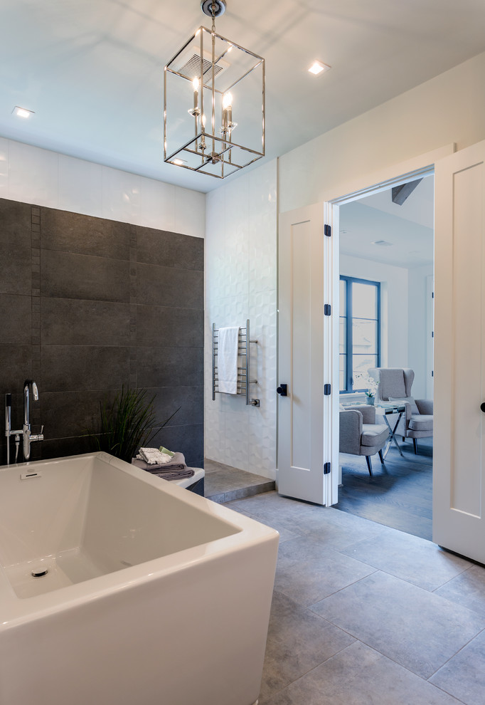 Inspiration for a mid-sized transitional master bathroom in Houston with flat-panel cabinets, white cabinets, a curbless shower, a one-piece toilet, gray tile, porcelain tile, orange walls, porcelain floors, a vessel sink, engineered quartz benchtops, grey floor, a sliding shower screen and black benchtops.