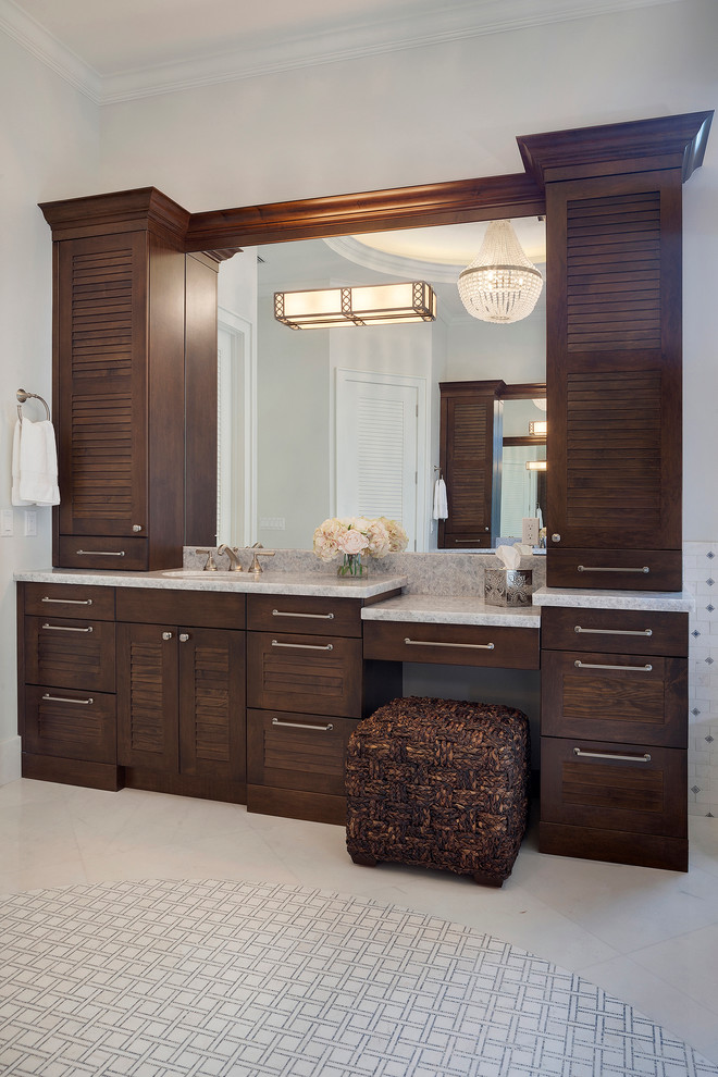 Large transitional master multicolored tile and ceramic tile porcelain tile and beige floor freestanding bathtub photo in Miami with louvered cabinets, dark wood cabinets, a one-piece toilet, gray walls, an undermount sink, marble countertops and gray countertops