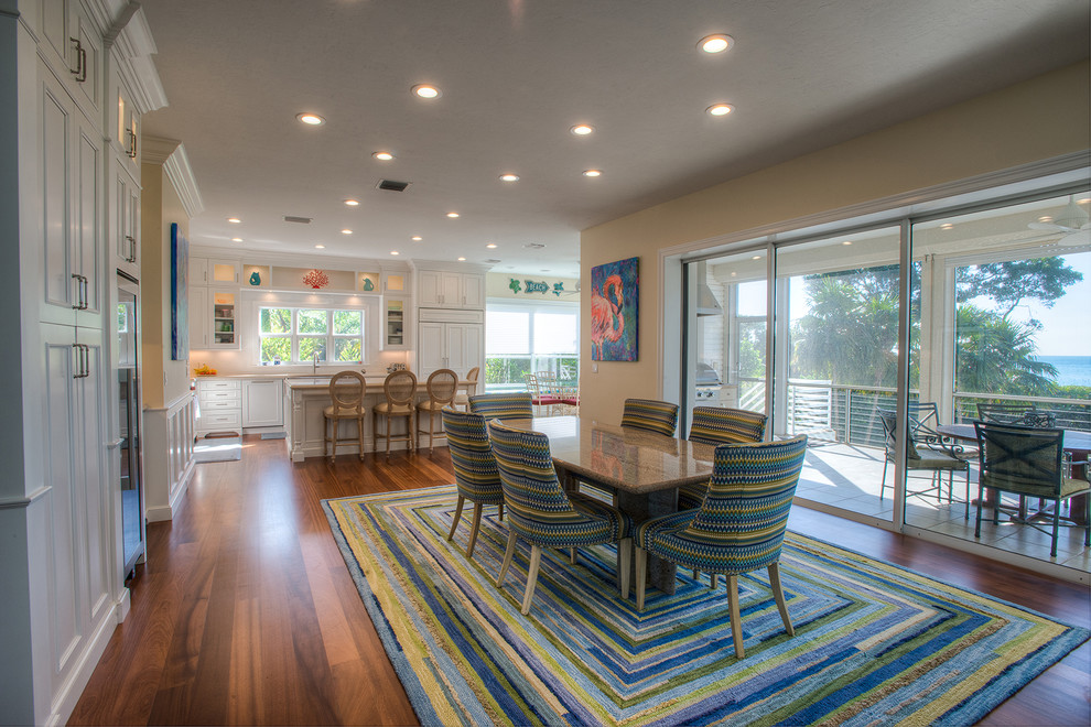Mid-sized beach style medium tone wood floor kitchen/dining room combo photo in Miami with beige walls