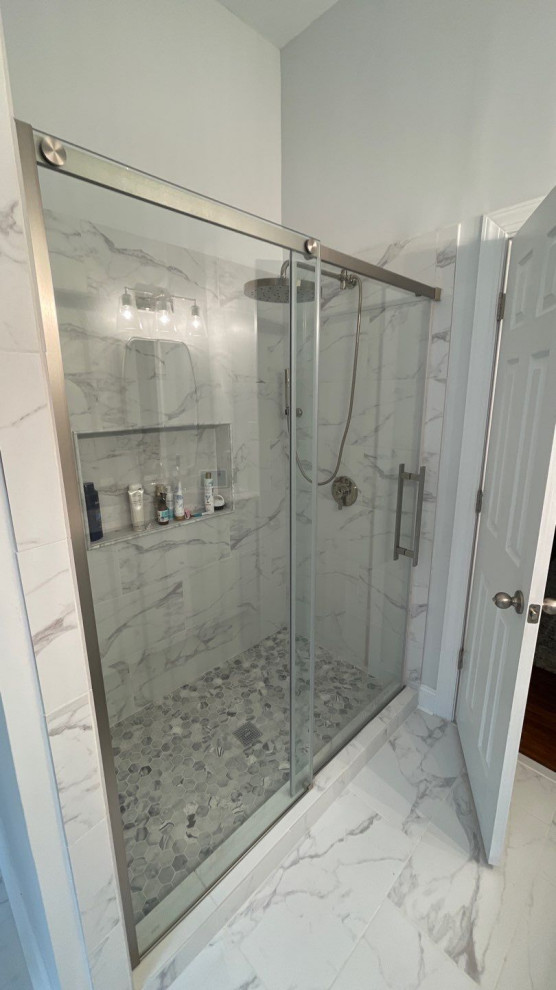 This is an example of a mid-sized contemporary master bathroom in Richmond with raised-panel cabinets, white cabinets, a freestanding tub, an alcove shower, a two-piece toilet, multi-coloured tile, marble, grey walls, marble floors, an undermount sink, marble benchtops, multi-coloured floor, a sliding shower screen, multi-coloured benchtops, a niche, a double vanity, a freestanding vanity and vaulted.