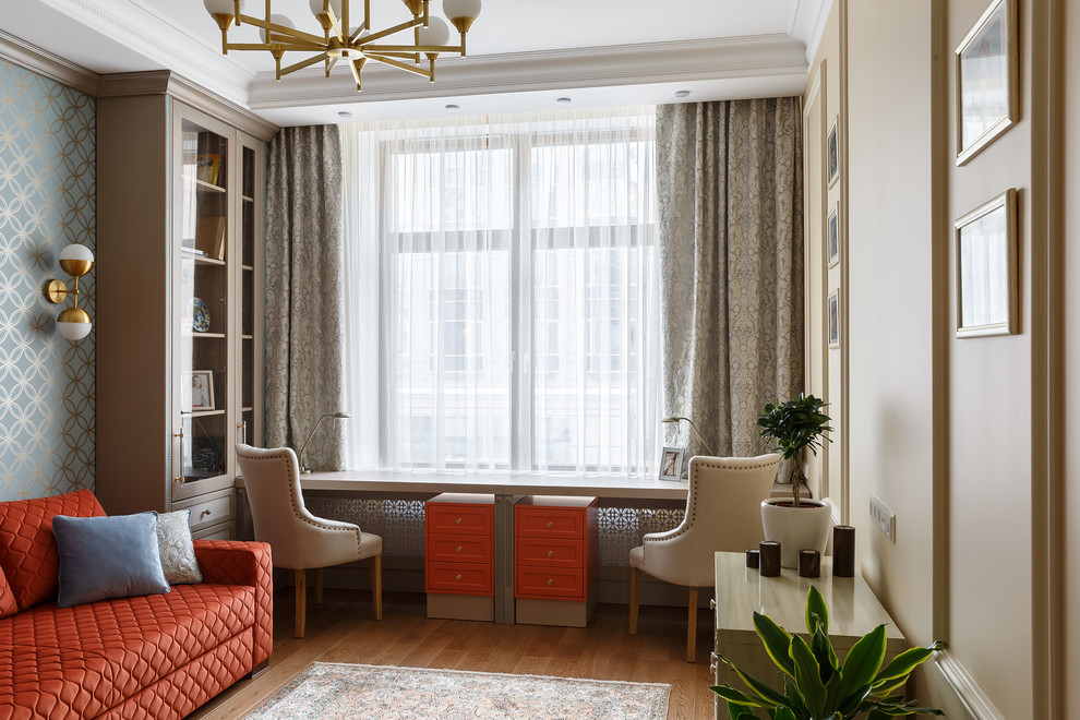 This is an example of a transitional study room in Saint Petersburg with beige walls, medium hardwood floors, a freestanding desk and brown floor.