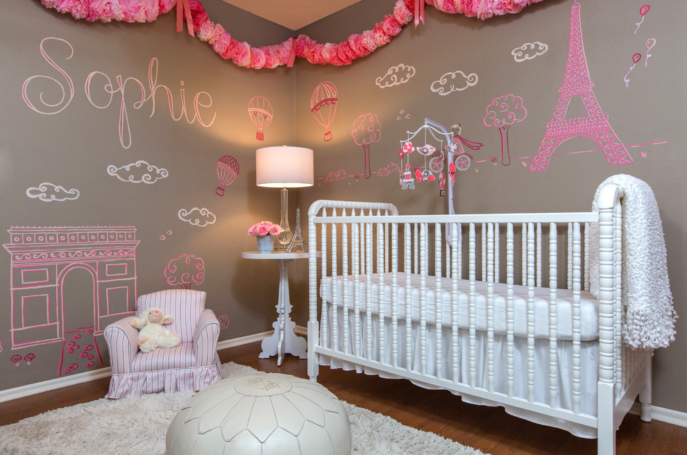 Photo of a mid-sized transitional nursery for girls in Orlando with brown walls and medium hardwood floors.