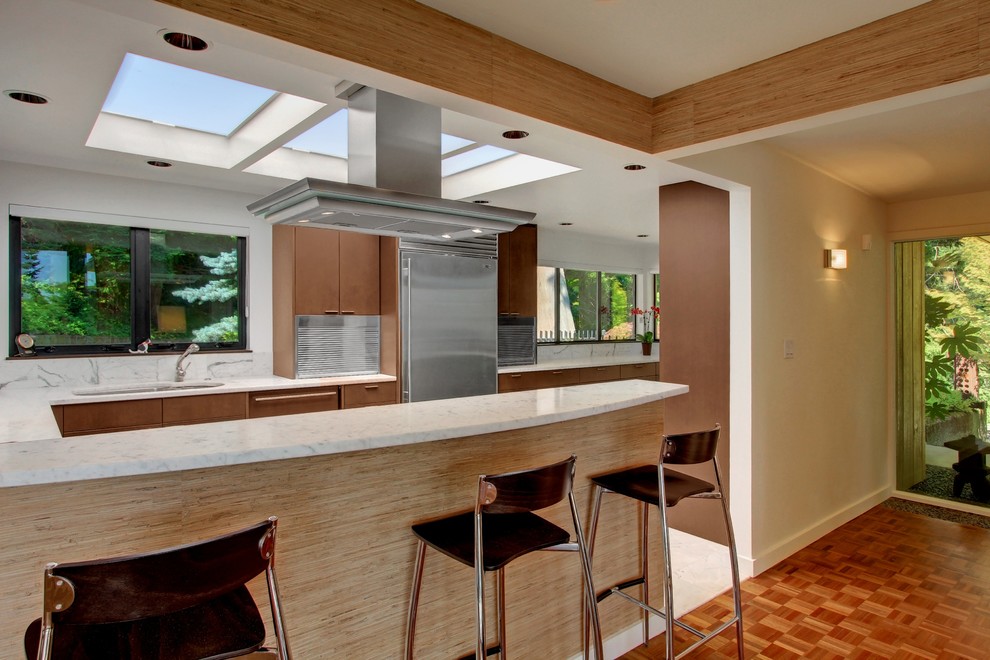 Design ideas for a midcentury eat-in kitchen in Seattle with an undermount sink, flat-panel cabinets, medium wood cabinets, marble benchtops, stainless steel appliances and marble floors.