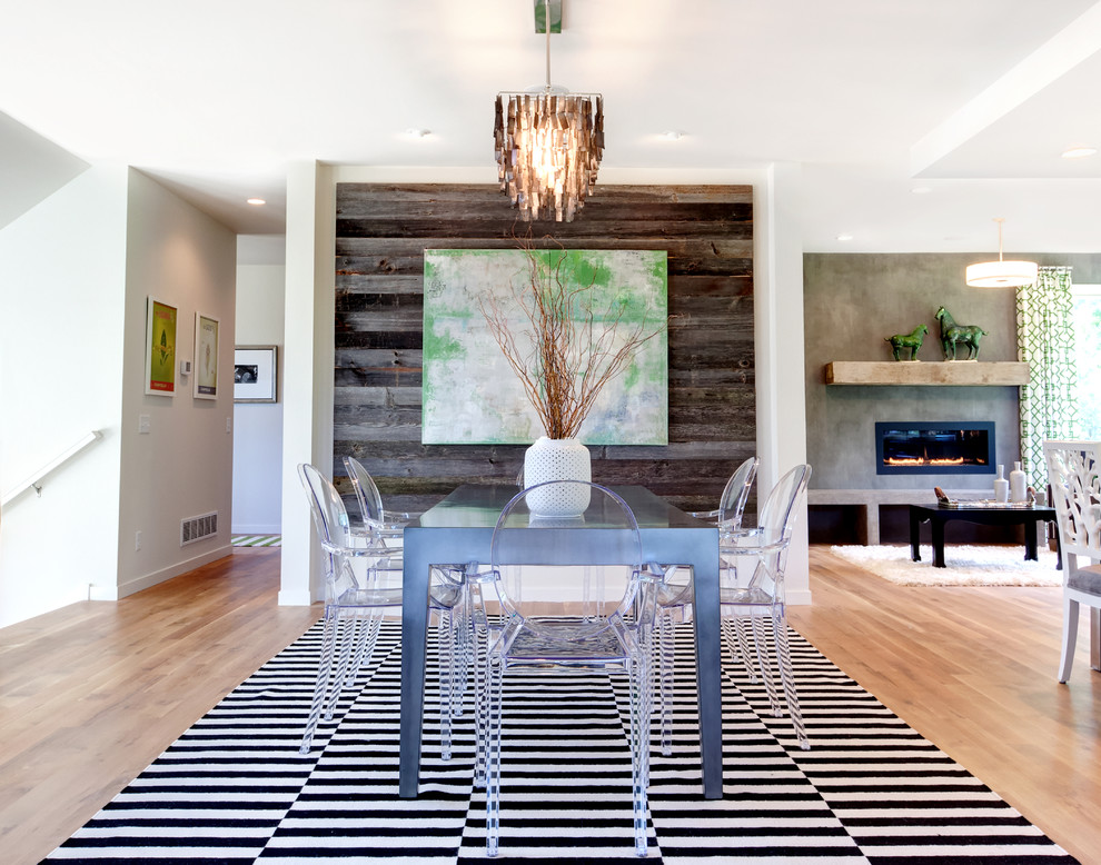 Contemporary open plan dining in Minneapolis with white walls and medium hardwood floors.