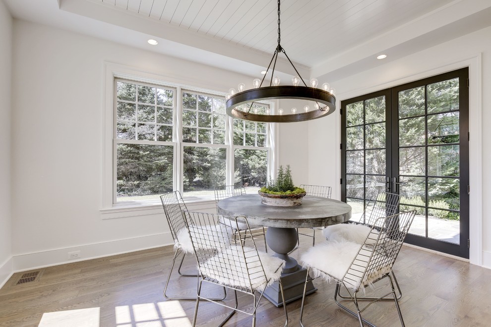 Inspiration for a transitional dining room in DC Metro with white walls, medium hardwood floors and brown floor.