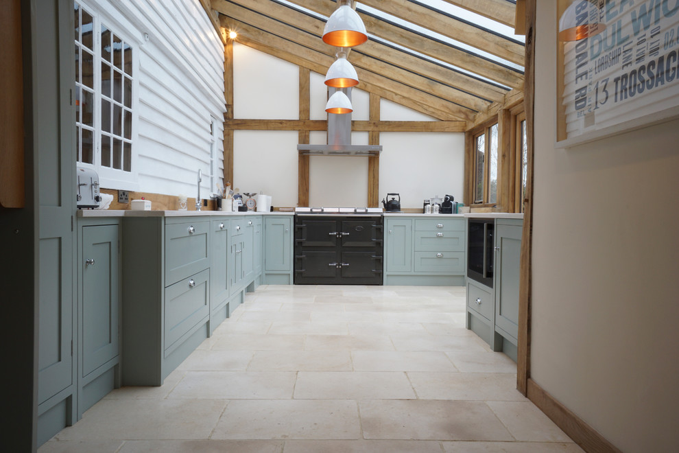 Mid-sized traditional kitchen in Kent with an undermount sink, shaker cabinets, green cabinets, quartzite benchtops, timber splashback, black appliances, travertine floors and no island.