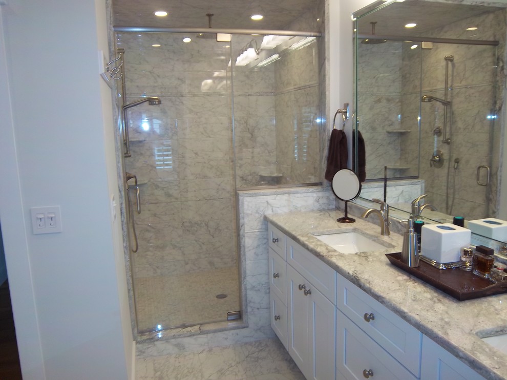 Alcove shower - mid-sized transitional 3/4 white tile and marble tile marble floor and white floor alcove shower idea with shaker cabinets, white cabinets, white walls, an undermount sink, granite countertops and a hinged shower door