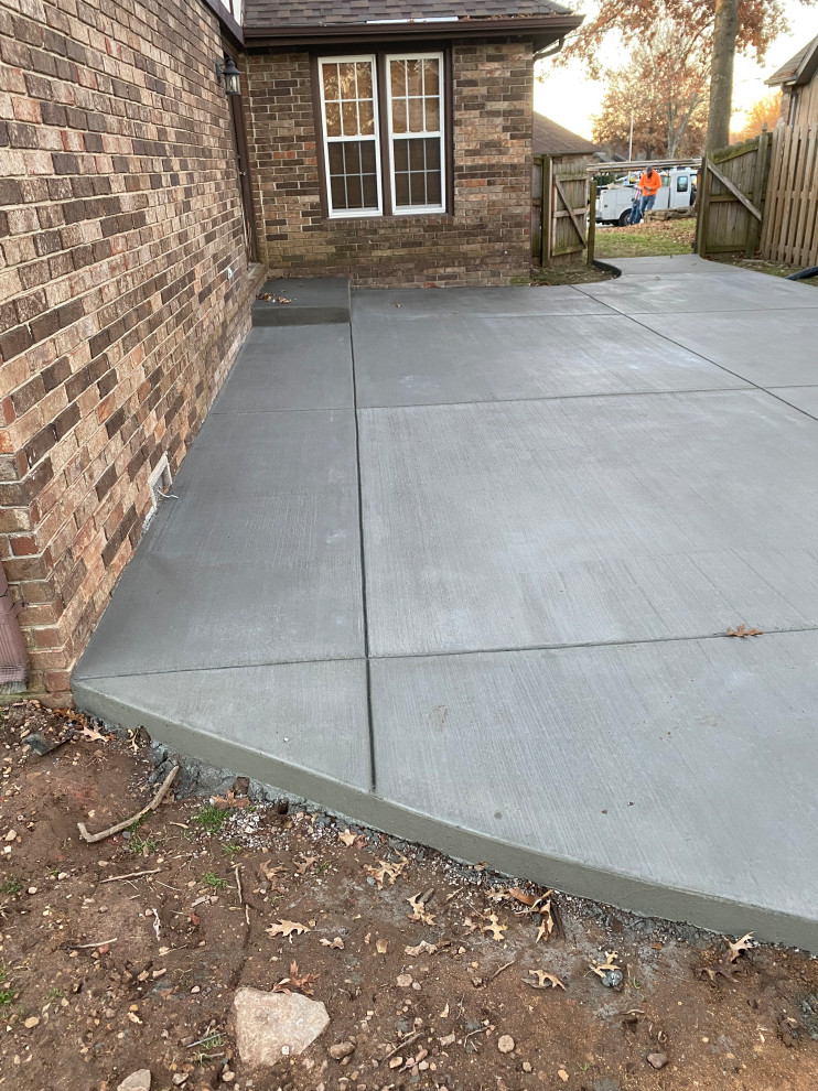 Example of a large backyard concrete patio design