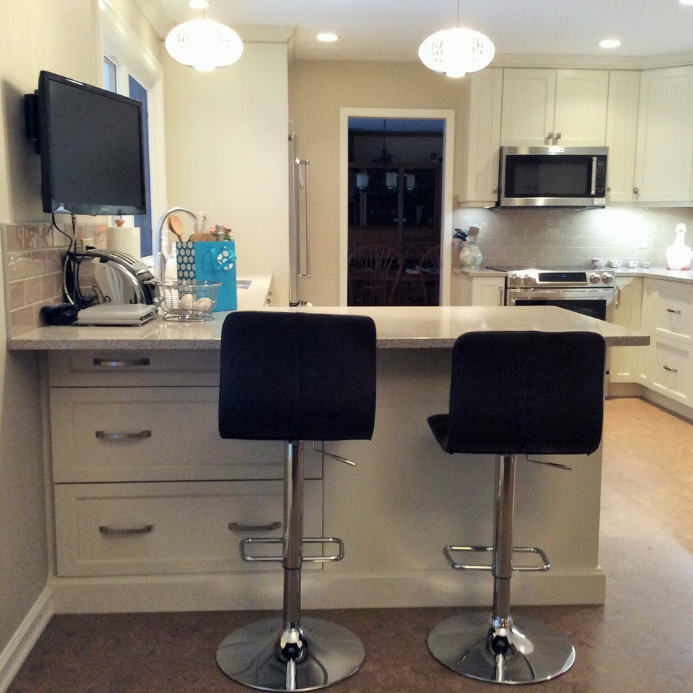 Inspiration for a transitional cork floor kitchen remodel in Edmonton with white cabinets, quartzite countertops, gray backsplash, ceramic backsplash and stainless steel appliances