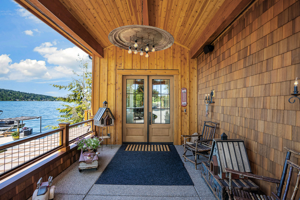 Front door - large rustic concrete floor, gray floor, wood ceiling and wood wall front door idea in Seattle with brown walls and a medium wood front door